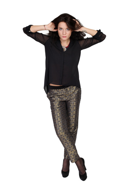fashion portrait of a girl in trousers and a black blouse - Foto, afbeelding