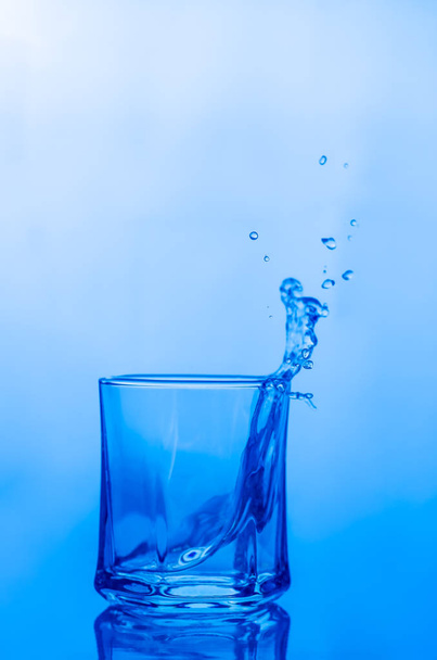 Water splash in a glass - Фото, изображение