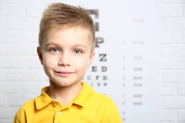 boy on ophthalmic test chart   - 写真・画像