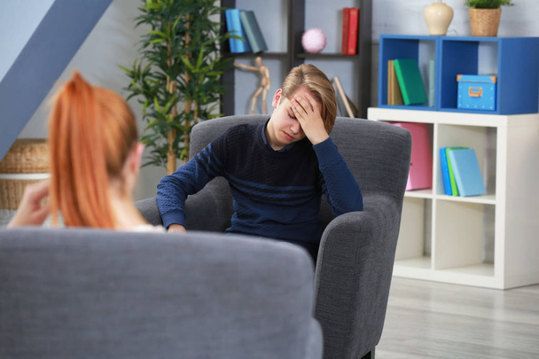 Depressed teenager having therapy session  - Photo, image