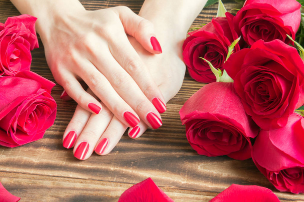 red nail manicure with red roses around - Photo, Image