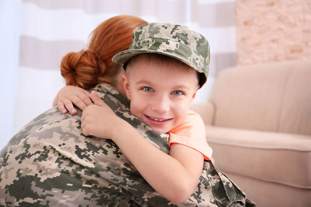 female  soldier and little kid - Foto, afbeelding