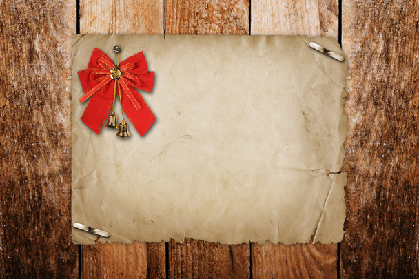 Christmas bells with red bow on the wooden background - Φωτογραφία, εικόνα