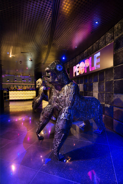 Dubai, United Arab Emirates, 08/080/2015, People by Crystal, Dubais best nightclub, Raffles. The iconic metal cog gorilla sculptures in a neon light setting. - Фото, изображение