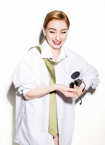 naked young woman in a mans white shirt with green tie holding glasess - Fotografie, Obrázek