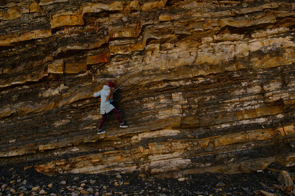 woman climbs over the rocks - Photo, Image