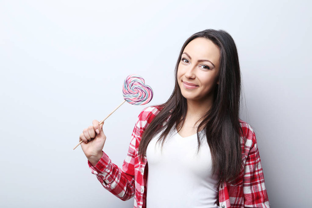 Young woman with lollipop - 写真・画像