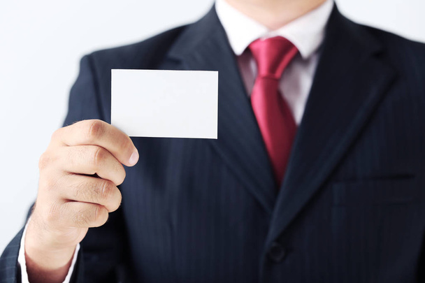 Businessman holding card  - Foto, Bild