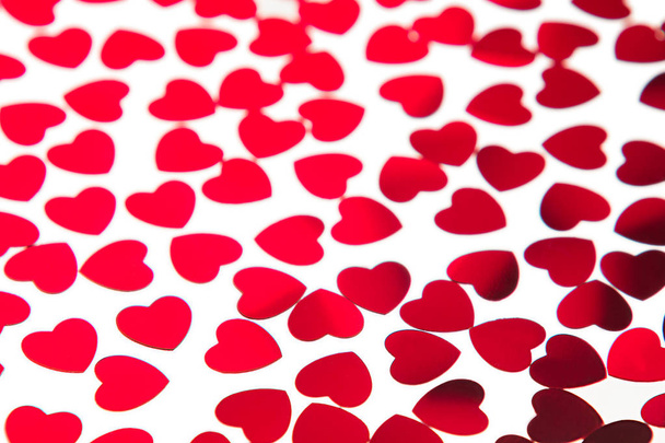 Valentines day pattern of red hearts confetti on white background. - Foto, immagini