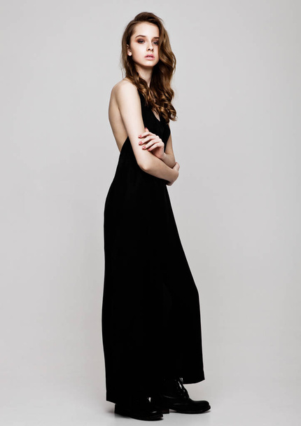 Young beautiful fashion model wearing black dress - 写真・画像