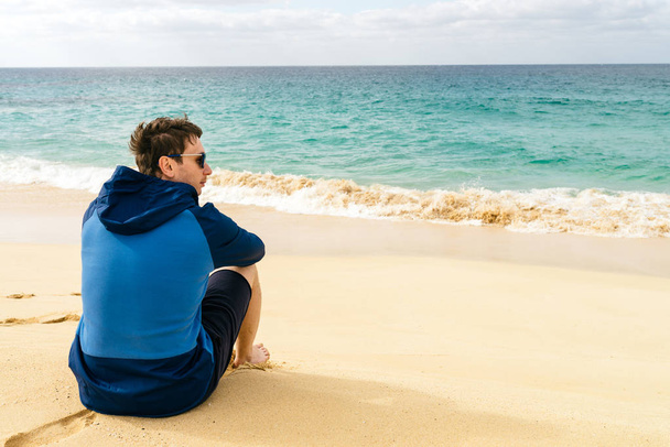 man looks at ocean on the paradise beach  - Fotoğraf, Görsel