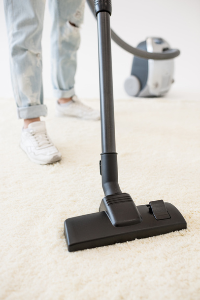 Woman vacuuming carpet - Fotó, kép