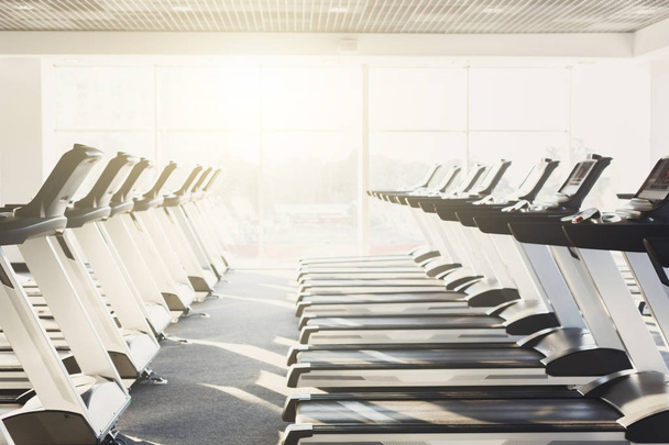 Modern gym interior with equipment, treadmills for fitness cardio training - Foto, immagini