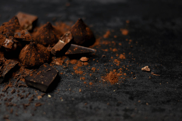 Set of chocolate, truffles and cocoa on rustic background  - Фото, зображення
