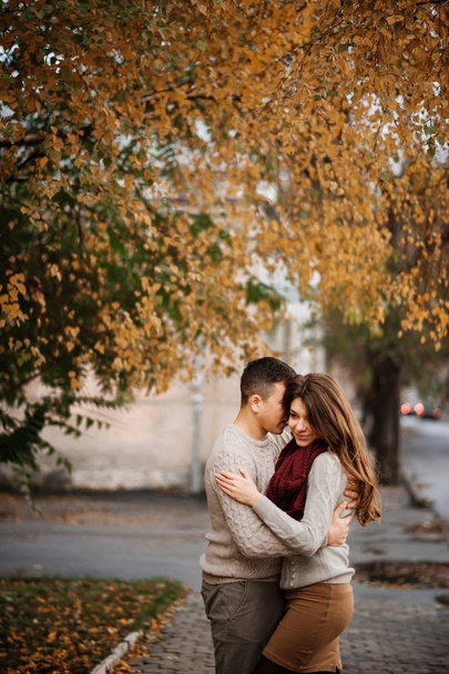 Young couple wearing on tied warm sweaters hugging in love at ci - Foto, immagini