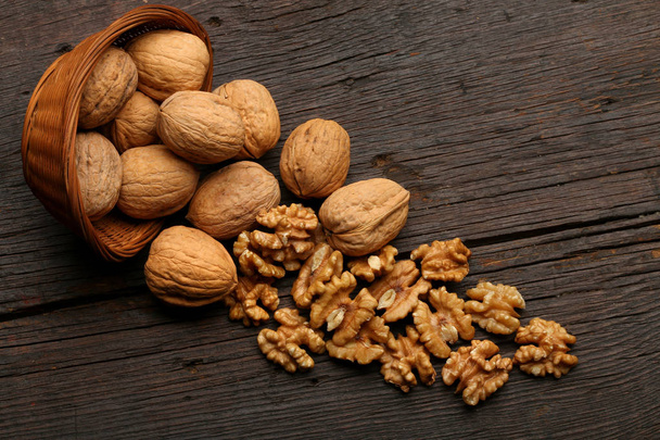 Group of delicious nuts in a bowl, over a wooden background - Foto, immagini