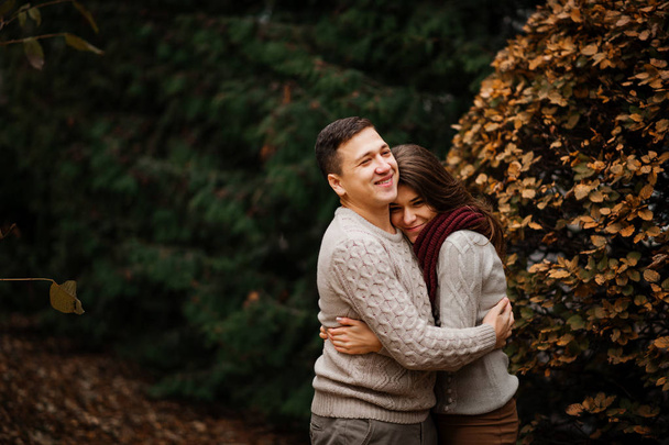 Young couple wearing on tied warm sweaters hugging in love at ci - Фото, зображення