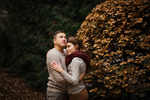 Young couple wearing on tied warm sweaters hugging in love at ci - Фото, зображення