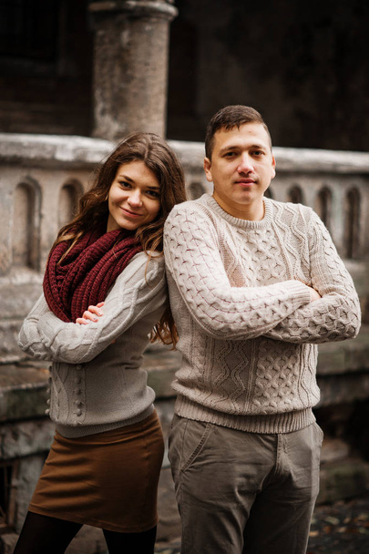 Young couple wearing on tied warm sweaters hugging in love at ol - Photo, image