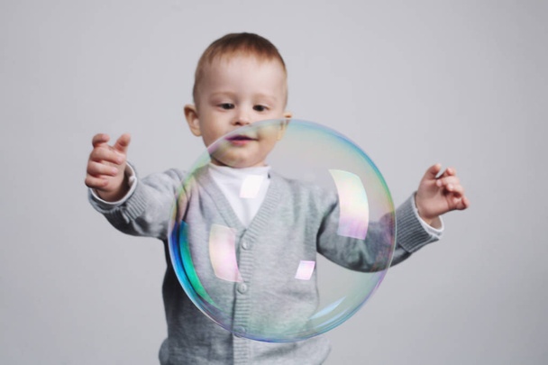 little funny boy plays with bubbles - 写真・画像