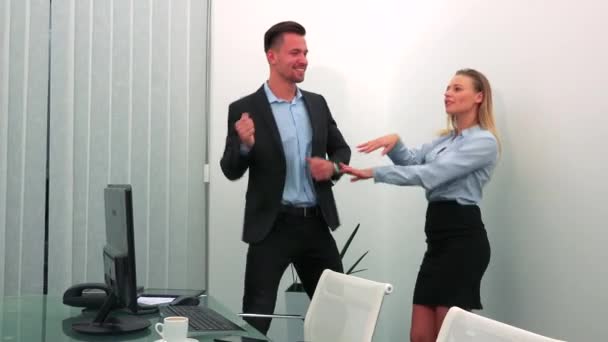 A man and a woman (both young and attractive) dance in an office - Video