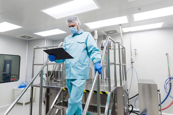 Wissenschaftler stehen auf Metalltreppe im Labor - Foto, Bild