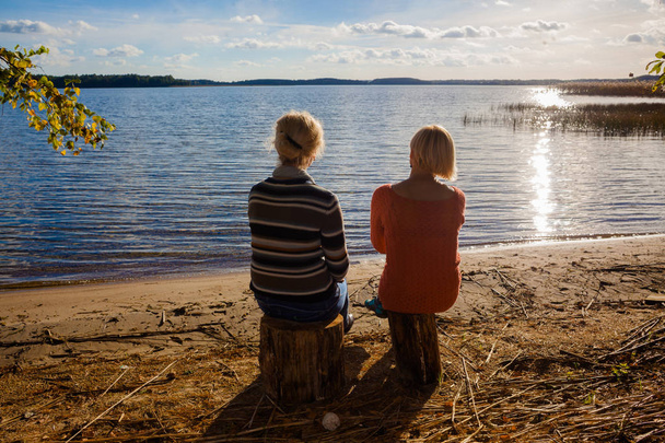 Two middle-aged women friends on the shore. - Fotoğraf, Görsel
