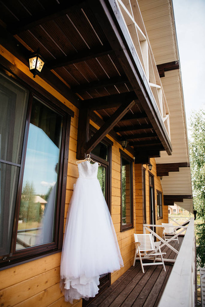 White wedding dress hanging on the balcony - 写真・画像