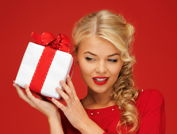 Lovely woman in red dress with present - Foto, afbeelding