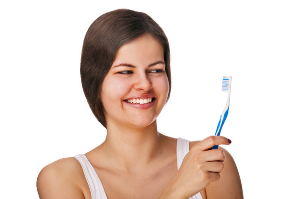 Woman with toothbrush smiling, isolated over white background. - Photo, Image