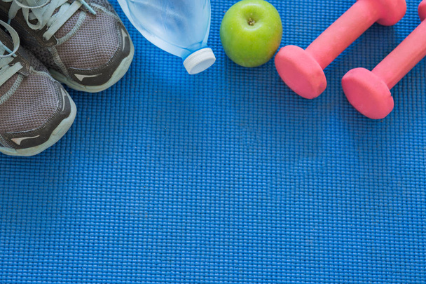 Sport equipment on blue mat. - Photo, Image