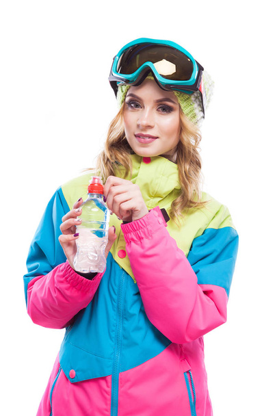 blonde girl with water bollte snowboard suit - Фото, изображение