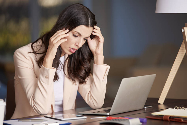 Stressed woman in the office  - 写真・画像