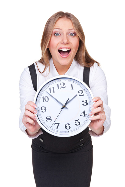 mujer joven asombrada mostrando el reloj
 - Foto, Imagen