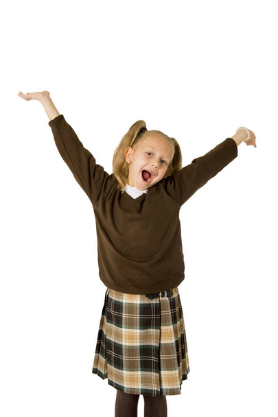 young beautiful happy schoolgirl in pigtails and uniform smiling happy and excited having fun - Photo, Image