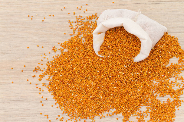 Red millet on wooden background - Photo, Image