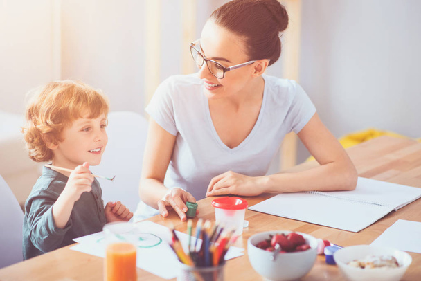Delighted mother drawing with her toddler son together - Photo, Image