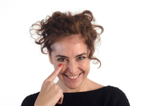 woman with gaze and finger in eye - Φωτογραφία, εικόνα