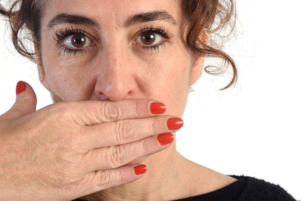 A woman with her mouth covered - Photo, Image