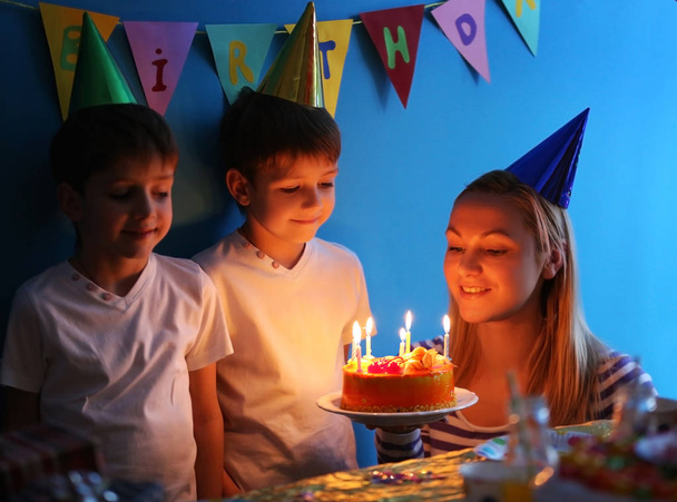 Mother with birthday cake for cute twins at party - Photo, image
