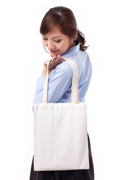 happy, smiling asian woman carrying reusable cotton bag - 写真・画像