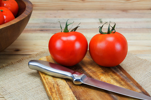 Closeup Fresh ripe tomatoes on wood background - 写真・画像