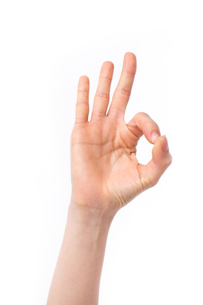 woman hand pointing up okay, yes, accepting hand sign, studio isolated - Foto, Imagen