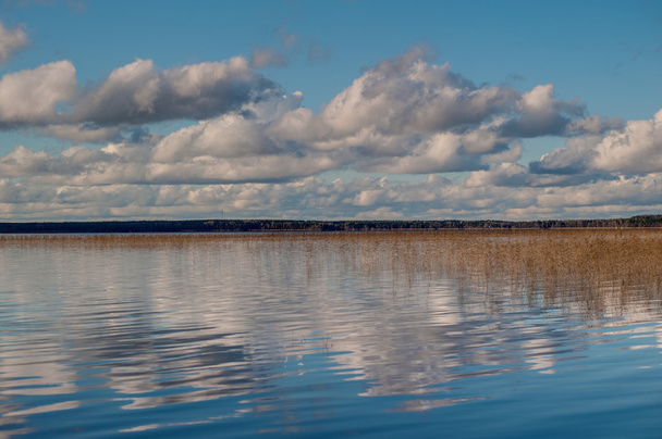 Clouds over the lake, autumn - Photo, image