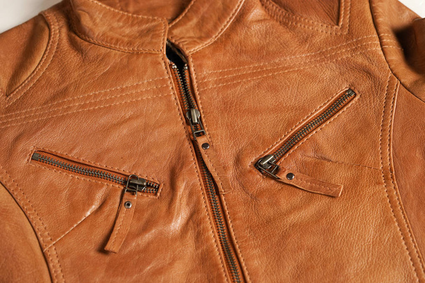 Light brown leather jacket. Beige color leather jacket on hanger.  - Zdjęcie, obraz
