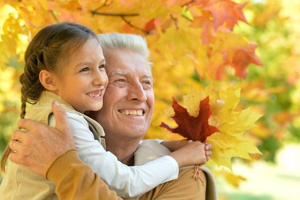 portrait of happy grandfather and granddaughter - Foto, imagen