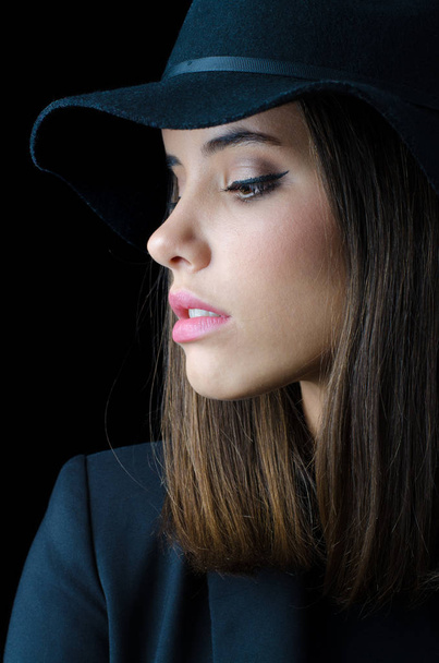 Portrait of the beautiful elegant girl in black jacket and black hat - Foto, imagen
