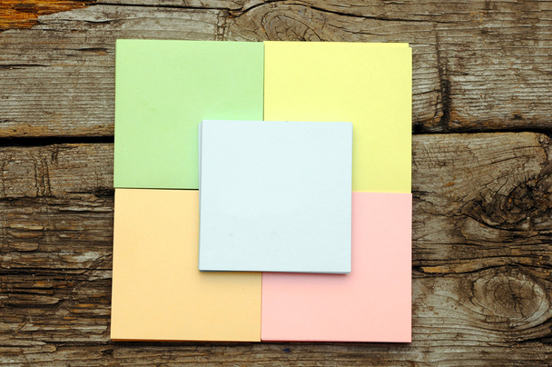 Stack of colorful sticky notes on wooden background - Foto, Bild