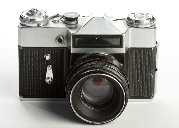 The frontal view of an old and dusty russian Zenit camera on film with lens. - Zdjęcie, obraz