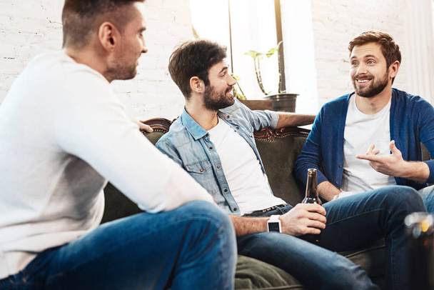 Cheerful bearded man telling his friends a story - Photo, Image